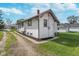 Charming home exterior featuring white stucco, dark trim, and well-maintained landscaping at 2735 S Taft Ave, Indianapolis, IN 46241