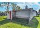 Exterior view of a storage shed with a sunflower design, vinyl siding, and a chain link fence at 2735 S Taft Ave, Indianapolis, IN 46241