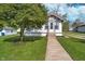 Charming home featuring a well-maintained lawn and a classic facade with a inviting front porch at 2735 S Taft Ave, Indianapolis, IN 46241