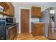 A quaint kitchen with a stainless steel refrigerator and wooden cabinets, with access to additional storage space at 2735 S Taft Ave, Indianapolis, IN 46241