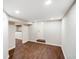 Unfinished basement space featuring wood-look flooring and a door to the exterior at 2926 Indianapolis Ave, Indianapolis, IN 46208