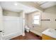 Bright bathroom featuring a shower/tub combo, toilet, and stylish vanity at 2926 Indianapolis Ave, Indianapolis, IN 46208