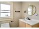 Modern bathroom features a stylish vanity, round mirror, and sleek black hardware accents at 2926 Indianapolis Ave, Indianapolis, IN 46208