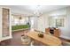 Open dining room next to kitchen with brick accent wall, chandelier, and nice furniture at 2926 Indianapolis Ave, Indianapolis, IN 46208