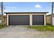 View of two-car garage with dark gray doors, set against a blue sky at 2926 Indianapolis Ave, Indianapolis, IN 46208