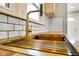 Close up of the kitchen sink, butcher block counters and subway tile backsplash at 2926 Indianapolis Ave, Indianapolis, IN 46208
