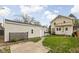 Shot of backyard and garage with concrete sidewalk at 310 W 43Rd St, Indianapolis, IN 46208
