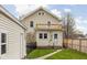 View of the home's backyard showcasing the outdoor upper deck and grass area at 310 W 43Rd St, Indianapolis, IN 46208