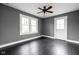 Charming bedroom features hardwood floors, a ceiling fan, neutral paint, and bright windows at 310 W 43Rd St, Indianapolis, IN 46208