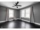 Charming bedroom features hardwood floors, a ceiling fan, neutral paint, and well-lit windows at 310 W 43Rd St, Indianapolis, IN 46208