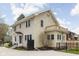 Charming two-story home features a side deck, mature trees, and a well-maintained front yard at 310 W 43Rd St, Indianapolis, IN 46208