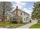 Beautiful two-story house featuring vinyl siding, a long driveway and lush greenery in a residential neighborhood at 310 W 43Rd St, Indianapolis, IN 46208