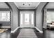 Stylish foyer with dark hardwood floors, a patterned rug, and arched doorways leading to other rooms at 310 W 43Rd St, Indianapolis, IN 46208