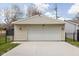 A two-car detached garage with a white garage door and exterior lights at 310 W 43Rd St, Indianapolis, IN 46208