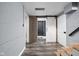 Inviting hallway with wood-look floors, gray walls, and access to a modern bathroom at 310 W 43Rd St, Indianapolis, IN 46208