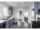 Charming kitchen features updated blue cabinets, stainless steel appliances, and modern lighting at 310 W 43Rd St, Indianapolis, IN 46208
