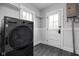 Functional laundry area includes washer/dryer and access to the backyard at 310 W 43Rd St, Indianapolis, IN 46208