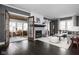 Spacious living room featuring a fireplace, hardwood floors, neutral decor, and a sunroom to the side at 310 W 43Rd St, Indianapolis, IN 46208