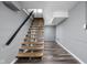 Stylish staircase with wood treads, black railing, and gray walls leads to the next level at 310 W 43Rd St, Indianapolis, IN 46208