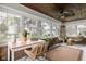 Bright sunroom with large windows, brick accents, a ceiling fan, and comfortable seating at 310 W 43Rd St, Indianapolis, IN 46208