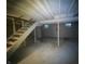 Unfinished basement with concrete floors and stairs leading up at 3202 Acacia Dr, Indianapolis, IN 46214