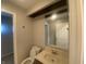Bathroom vanity featuring a mirror, sink, toilet, and doorway leading to the next room at 3202 Acacia Dr, Indianapolis, IN 46214