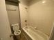 This bathroom features a toilet and bathtub with tiled walls at 3202 Acacia Dr, Indianapolis, IN 46214