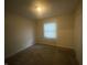 This bedroom has a window with blinds, neutral-colored walls and a closet at 3202 Acacia Dr, Indianapolis, IN 46214