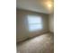 This bedroom has a window with blinds and neutral-colored walls at 3202 Acacia Dr, Indianapolis, IN 46214