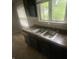 Functional kitchen featuring a stainless steel double sink under a bright window at 3202 Acacia Dr, Indianapolis, IN 46214