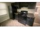 Well-equipped kitchen with dark cabinetry, including a stove and refrigerator at 3202 Acacia Dr, Indianapolis, IN 46214