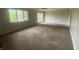 Expansive carpeted living room with abundant natural light and neutral walls at 3202 Acacia Dr, Indianapolis, IN 46214