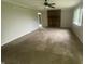 Spacious living room featuring a brick fireplace, large window, and neutral paint at 3202 Acacia Dr, Indianapolis, IN 46214