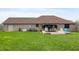 Expansive backyard with large brick home, patio, and lush lawn perfect for outdoor activities at 3300 E Indian Hill Dr, Muncie, IN 47302
