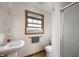 Cozy bathroom featuring a pedestal sink, toilet, and glass enclosed shower at 3300 E Indian Hill Dr, Muncie, IN 47302