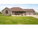 Charming brick home featuring an attached three car garage and a well-manicured front lawn at 3300 E Indian Hill Dr, Muncie, IN 47302