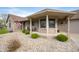 Inviting front porch with brick accents and landscaping, offering a cozy outdoor space at 3300 E Indian Hill Dr, Muncie, IN 47302