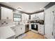 Well-lit kitchen featuring white cabinets and modern appliances, offering a functional and stylish cooking space at 3300 E Indian Hill Dr, Muncie, IN 47302