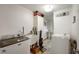 Functional laundry room equipped with washer, dryer, sink, and ample storage space at 3300 E Indian Hill Dr, Muncie, IN 47302