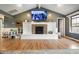 Comfortable living room featuring a brick fireplace, TV, and ample space for Gathering activities and relaxation at 3300 E Indian Hill Dr, Muncie, IN 47302