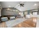 Spacious living room with a vaulted ceiling, ceiling fan, and wood floors providing a comfortable gathering space at 3300 E Indian Hill Dr, Muncie, IN 47302