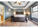 Comfortable main bedroom features wood floors, tray ceiling, and bright natural light at 3300 E Indian Hill Dr, Muncie, IN 47302