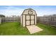 Backyard storage shed for tools and equipment with double doors and wooden ramp at 3300 E Indian Hill Dr, Muncie, IN 47302