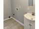 Bathroom featuring a white vanity, tan tile flooring and laundry hookups at 3502 N Illinois St, Indianapolis, IN 46208