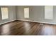 Bedroom featuring hardwood floors, neutral paint, and natural light from three large windows at 3502 N Illinois St, Indianapolis, IN 46208