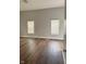 Spacious bedroom featuring hardwood floors, neutral paint, and natural light from two large windows at 3502 N Illinois St, Indianapolis, IN 46208