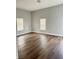 Spacious bedroom featuring hardwood floors, neutral paint, and natural light from two large windows at 3502 N Illinois St, Indianapolis, IN 46208