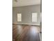 Spacious bedroom featuring hardwood floors, neutral paint, and natural light from two large windows at 3502 N Illinois St, Indianapolis, IN 46208