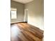 Bright bedroom with hardwood floors, neutral paint, and natural light through a large window at 3502 N Illinois St, Indianapolis, IN 46208
