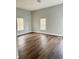 Spacious bedroom featuring hardwood floors, neutral paint, and natural light from two large windows at 3502 N Illinois St, Indianapolis, IN 46208